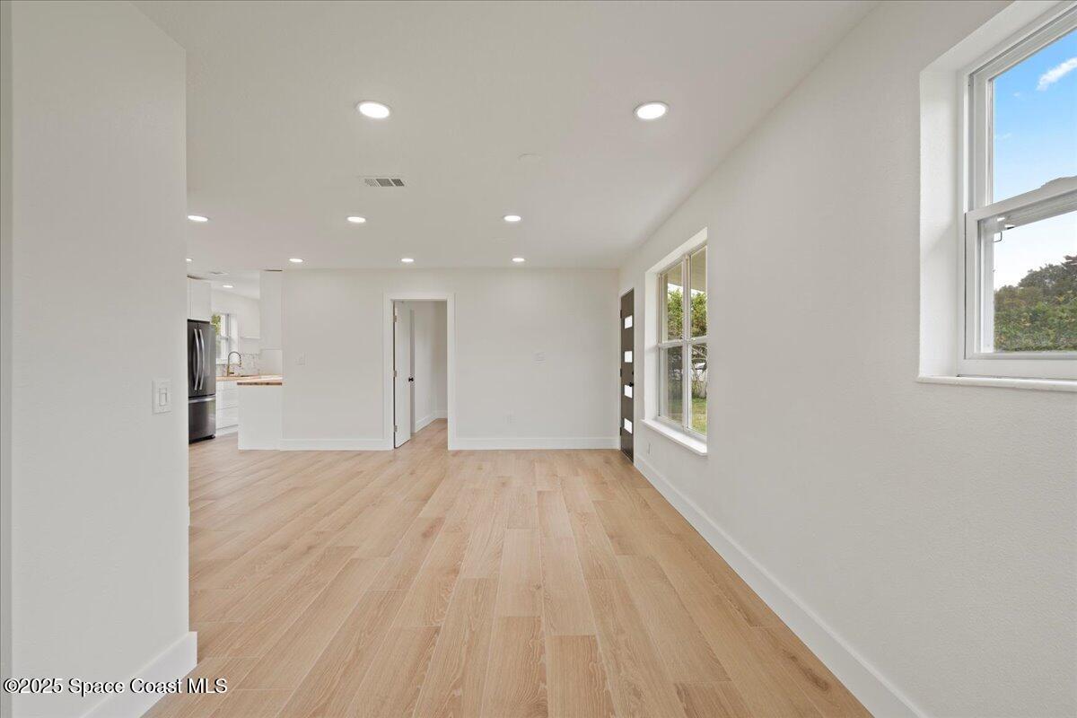 301 West Rutgers Street Melbourne, FL 32901 - Photo 14 of 36 a view of an empty room with wooden floor and a window