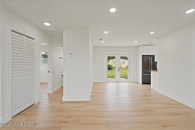 a view of an empty room with wooden floor