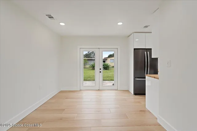a view of an empty room with glass door