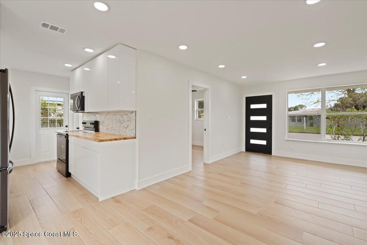 301 West Rutgers Street Melbourne, FL 32901 - Photo 21 of 36 a view of kitchen with cabinets and wooden floor