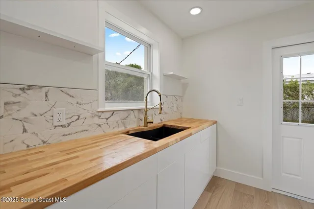 a bathroom with a sink and a window