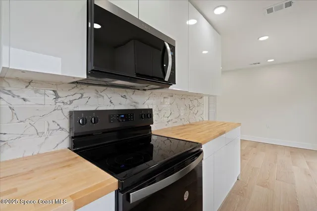a kitchen with a stove and a microwave