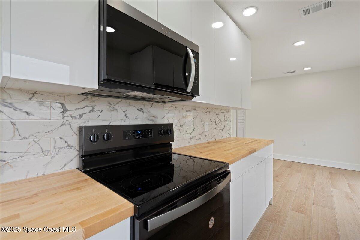 301 West Rutgers Street Melbourne, FL 32901 - Photo 26 of 36 a kitchen with a stove and a microwave