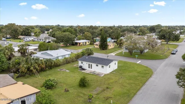 a view of a house with a yard and lake view