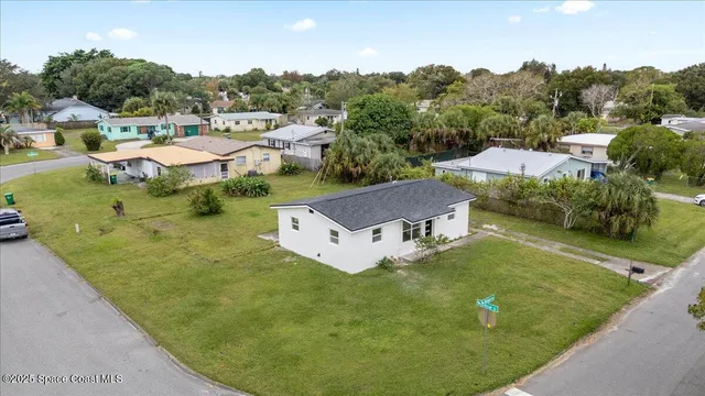 a view of a house with pool and a yard