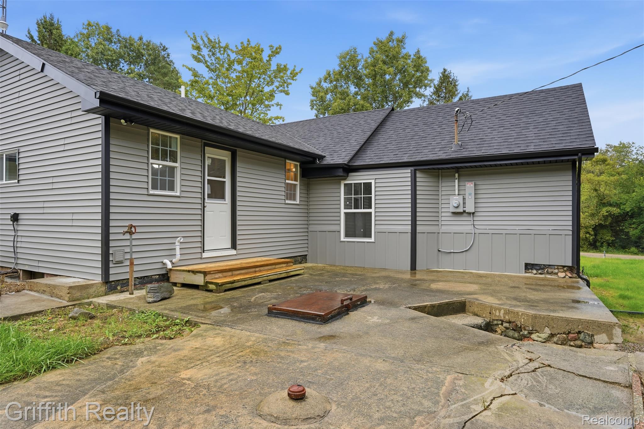 5820 Mack Road Howell, MI 48855 - Photo 36 of 60 Gray horizontal siding exterior with a black shingle roof