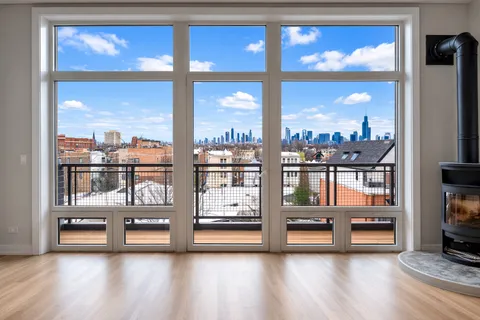 a view of front door with yard from ceiling windows