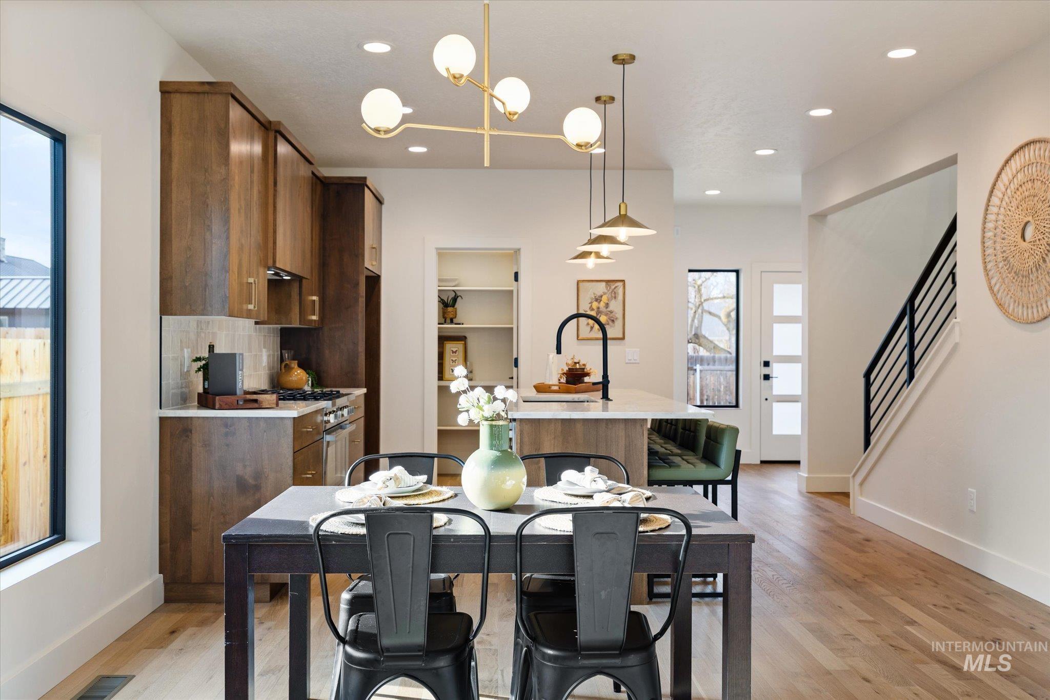 5612 West Grover Street Boise, ID 83705 - Photo 22 of 50 Dining area featuring light wood-style flooring, a chandelier, stairway, and recessed lighting