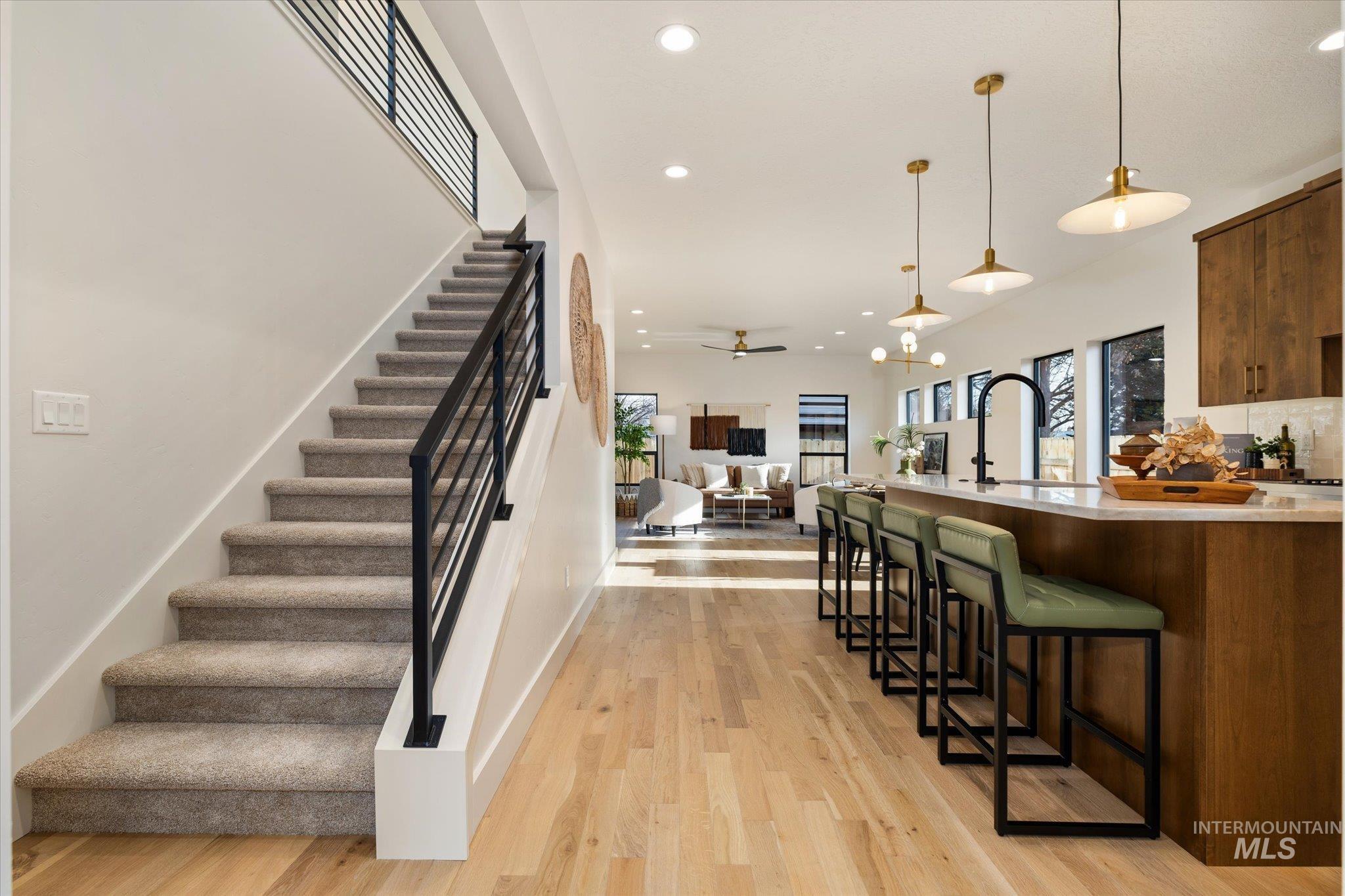 5612 West Grover Street Boise, ID 83705 - Photo 50 of 50 Kitchen featuring a breakfast bar area, hanging light fixtures, open floor plan, recessed lighting, and light wood-style flooring