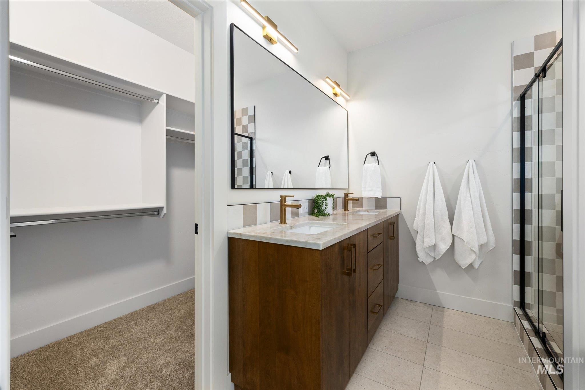 5612 West Grover Street Boise, ID 83705 - Photo 26 of 50 Full bath with a spacious closet, double vanity, a stall shower, and light carpet