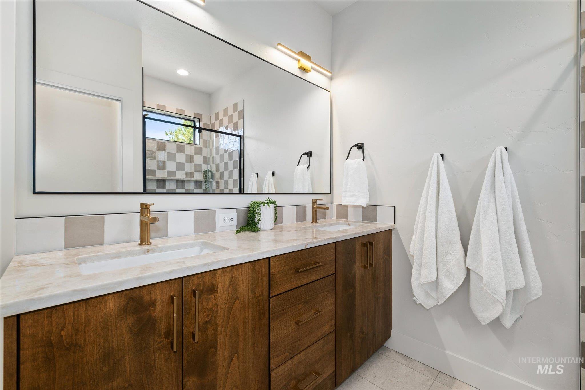 5612 West Grover Street Boise, ID 83705 - Photo 27 of 50 Bathroom featuring double vanity, a tile shower, and light tile patterned floors