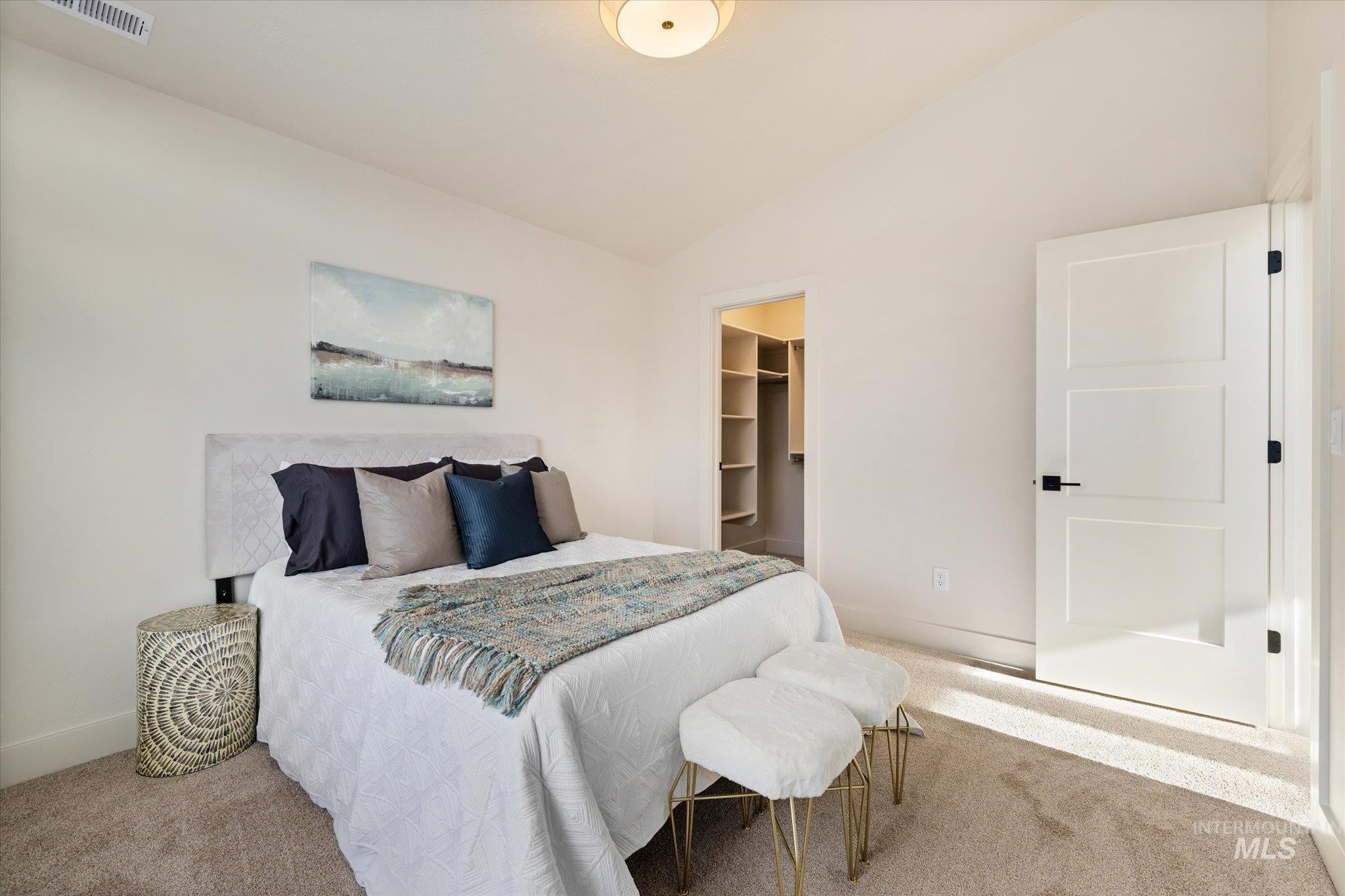 5612 West Grover Street Boise, ID 83705 - Photo 35 of 50 Carpeted bedroom with vaulted ceiling and a walk in closet