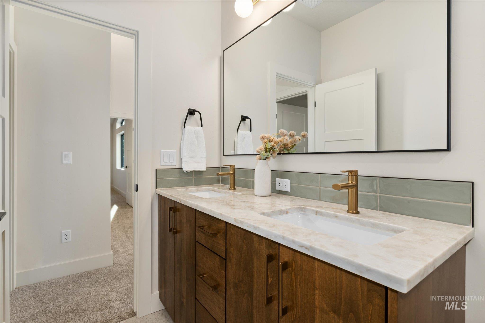 5612 West Grover Street Boise, ID 83705 - Photo 38 of 50 Full bathroom with double vanity, light colored carpet, and tasteful backsplash