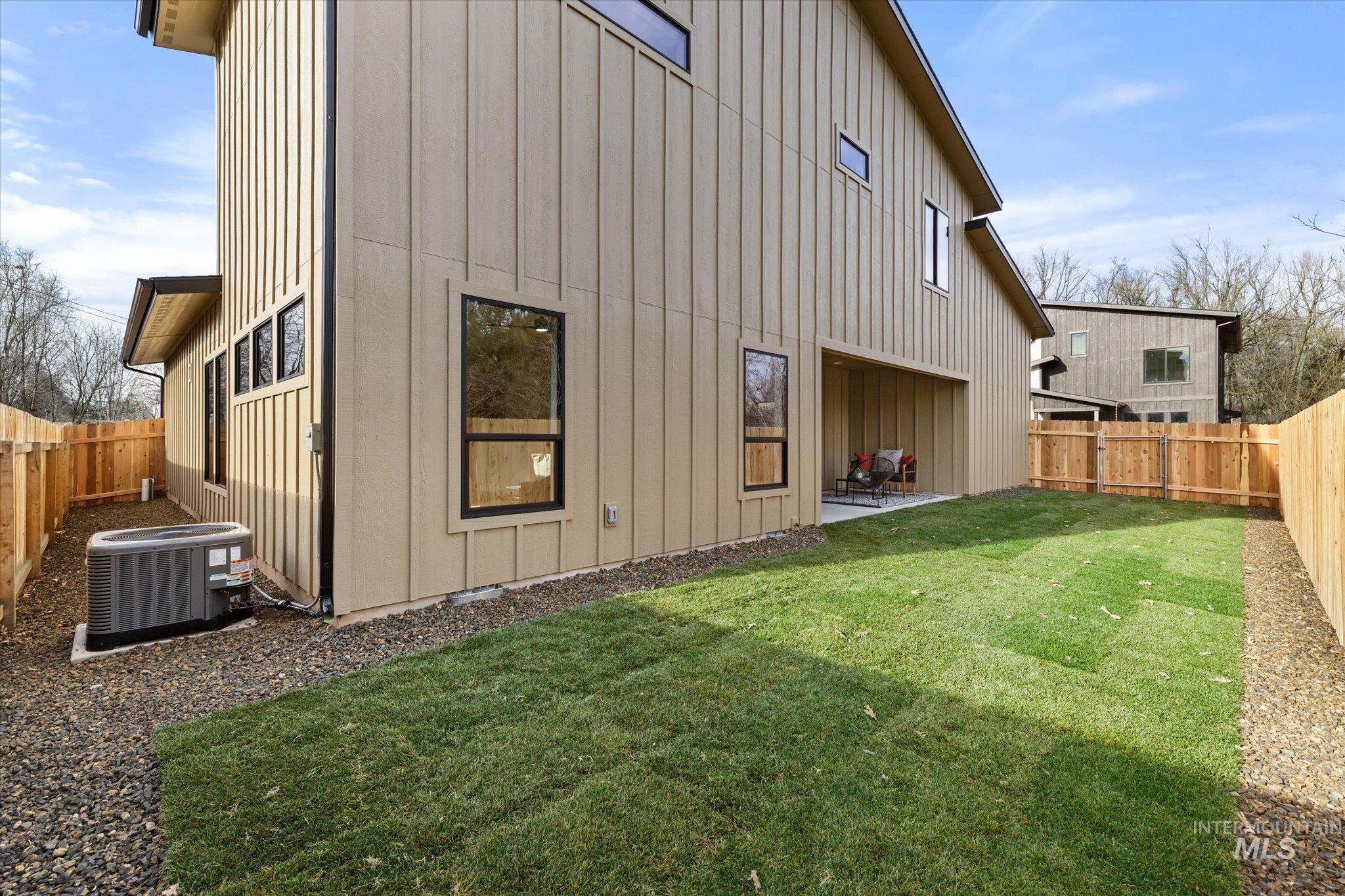 5612 West Grover Street Boise, ID 83705 - Photo 4 of 50 Back of house with a fenced backyard, board and batten siding, and a patio area