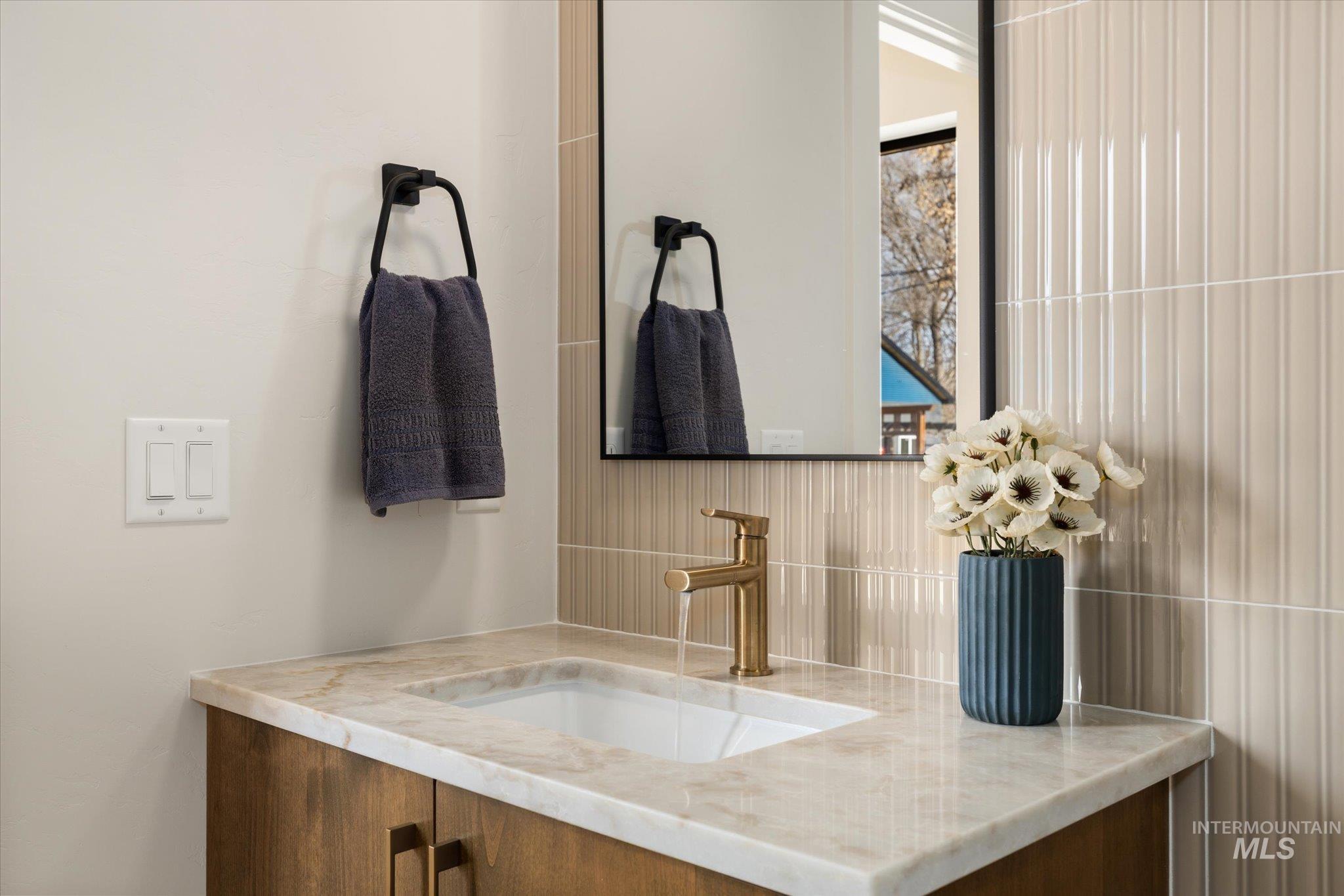 5612 West Grover Street Boise, ID 83705 - Photo 42 of 50 Bathroom featuring vanity and decorative backsplash