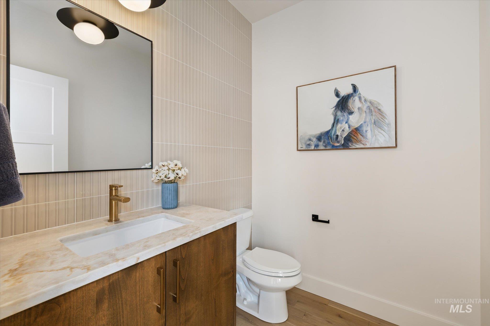 5612 West Grover Street Boise, ID 83705 - Photo 43 of 50 Bathroom with vanity, light wood-type flooring, tile walls, and decorative backsplash