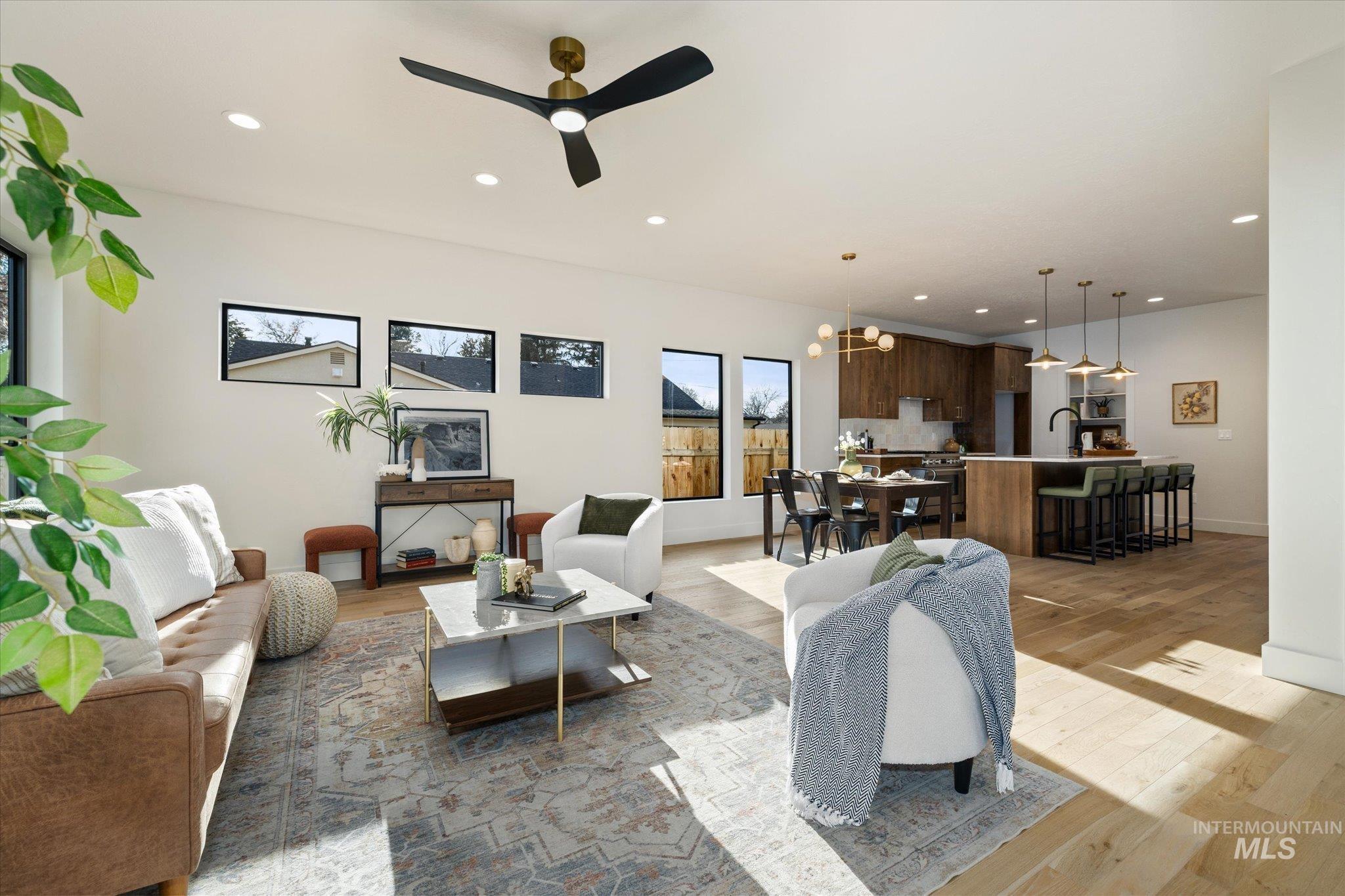 5612 West Grover Street Boise, ID 83705 - Photo 9 of 50 Living area featuring light wood finished floors, a chandelier, ceiling fan, and recessed lighting