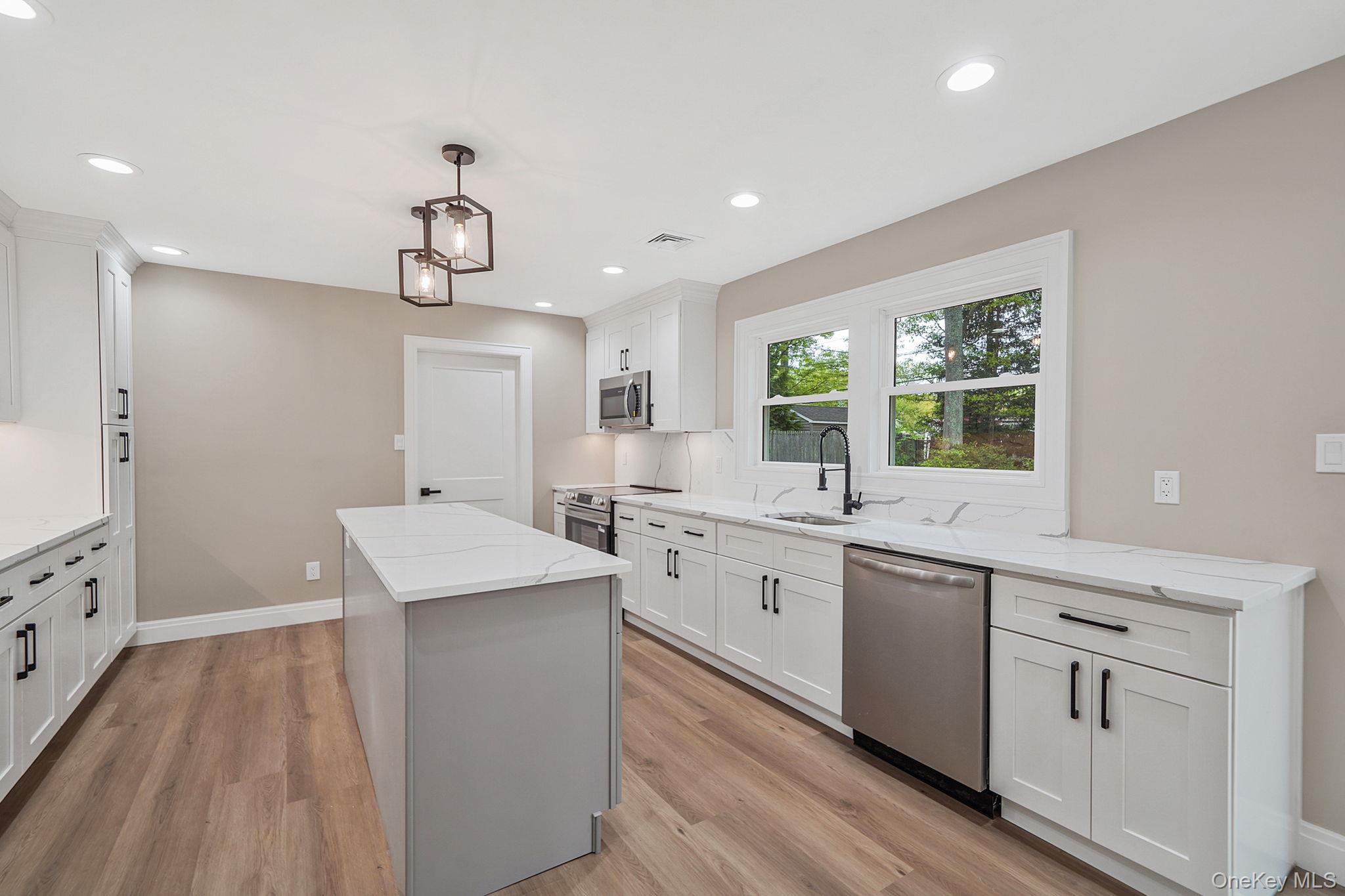 41 Winside Lane Coram, NY 11727 - Photo 11 of 33 designer kitchen with quartz countertops and backsplash