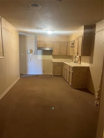 a view of a kitchen with a sink and dishwasher with wooden floor