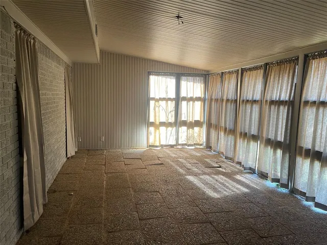 a bathroom with a toilet and a shower curtain