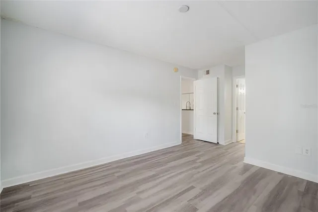 a view of an empty room and wooden floor