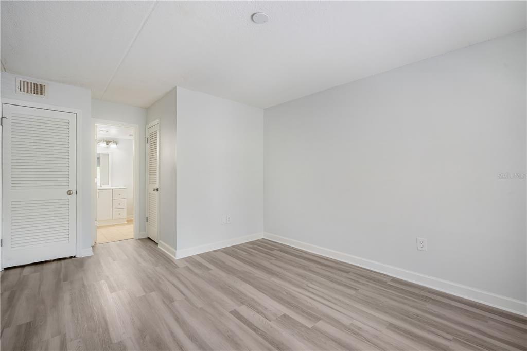 5305 San Sebastian Court, Unit 125 Tampa, FL 33609 - Photo 13 of 21 a view of an empty room with wooden floor
