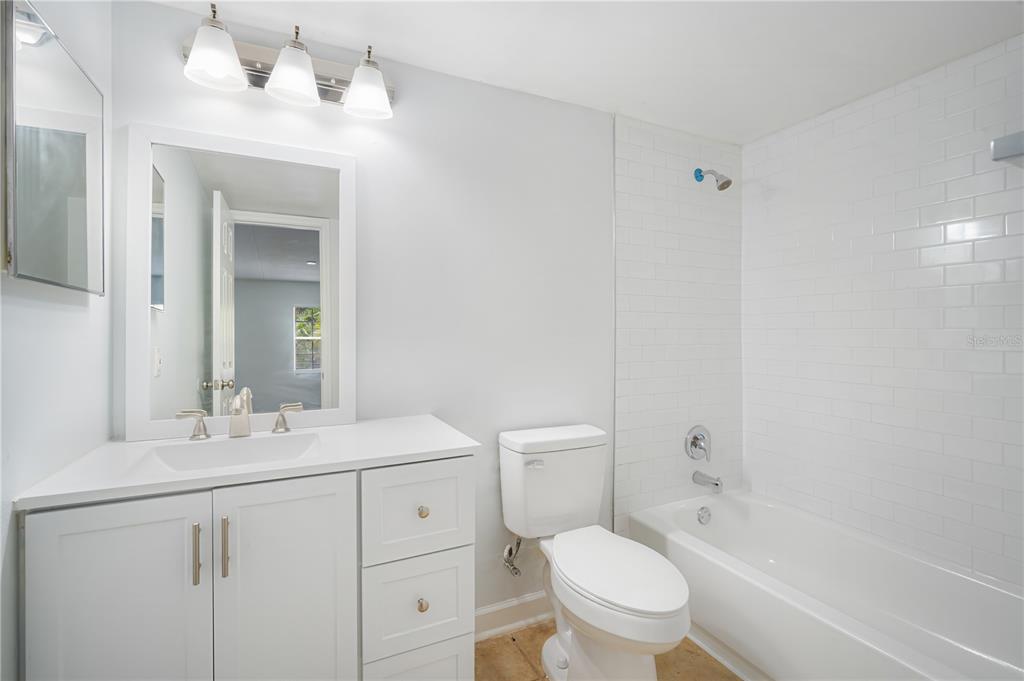 5305 San Sebastian Court, Unit 125 Tampa, FL 33609 - Photo 14 of 21 a bathroom with a sink a toilet and shower