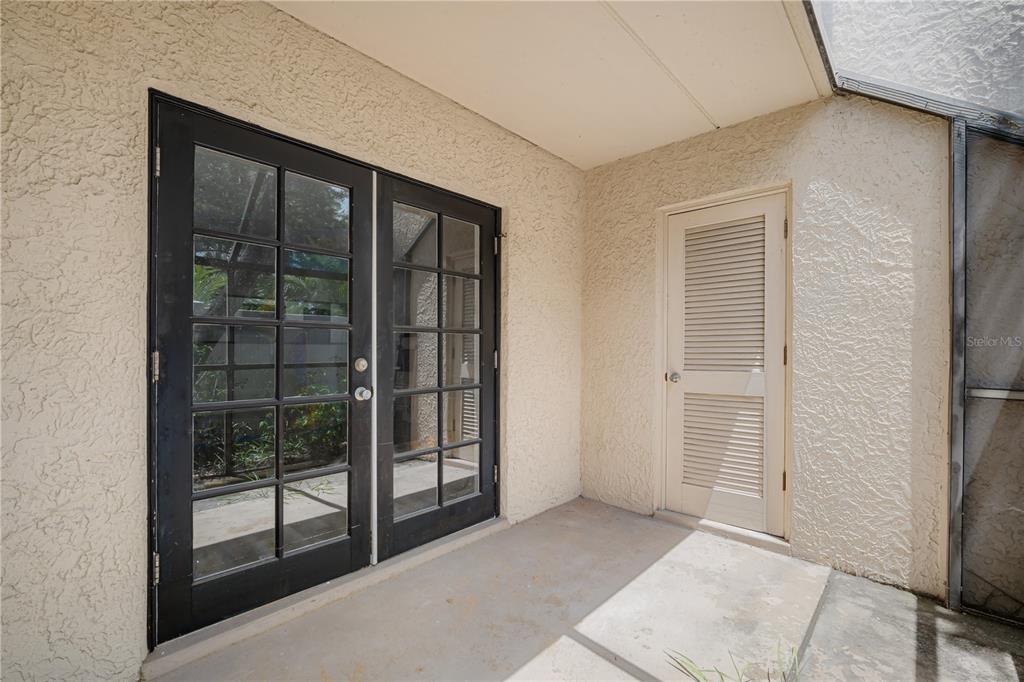 5305 San Sebastian Court, Unit 125 Tampa, FL 33609 - Photo 17 of 21 an empty room with sliding glass door
