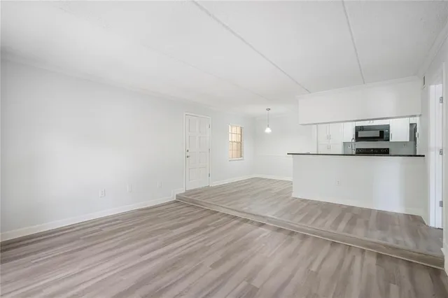 a view of a kitchen with microwave and cabinets