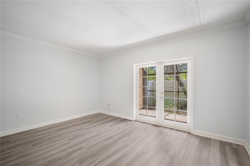 5305 San Sebastian Court, Unit 125 Tampa, FL 33609 - Photo 4 of 21 an empty room with wooden floor and windows