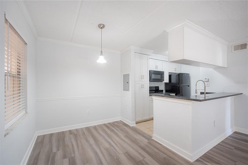 5305 San Sebastian Court, Unit 125 Tampa, FL 33609 - Photo 5 of 21 a kitchen with stainless steel appliances a sink a stove a refrigerator and cabinets