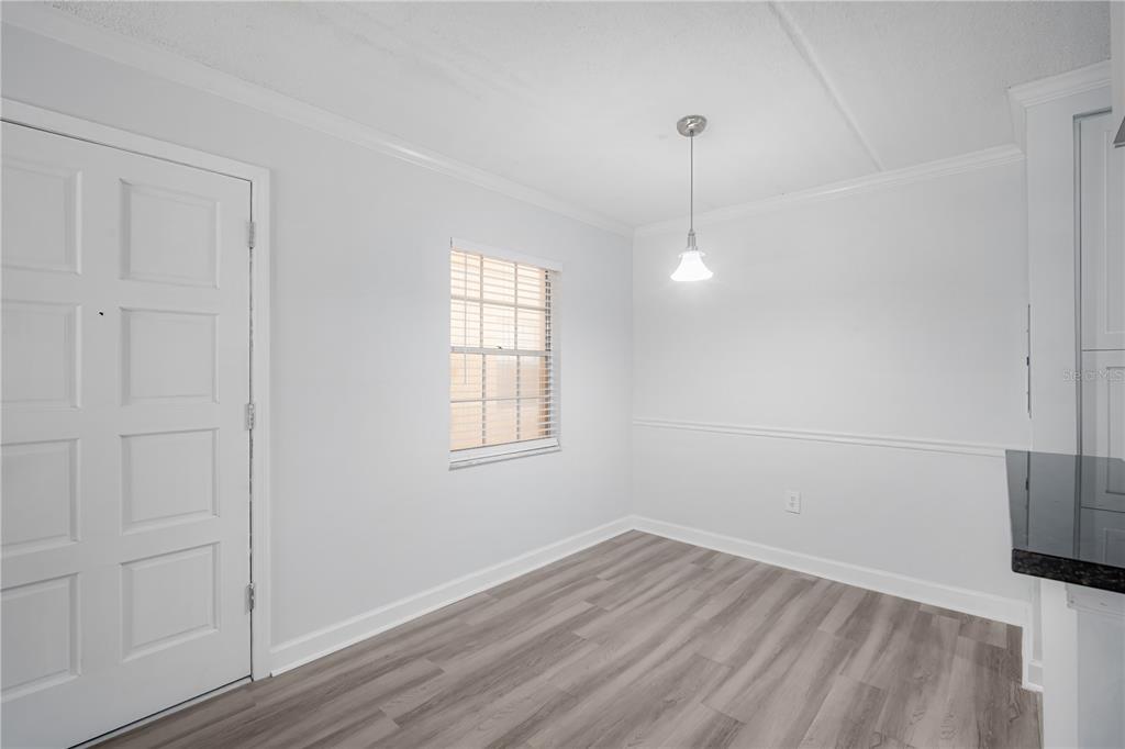 5305 San Sebastian Court, Unit 125 Tampa, FL 33609 - Photo 6 of 21 an empty room with wooden floor and windows