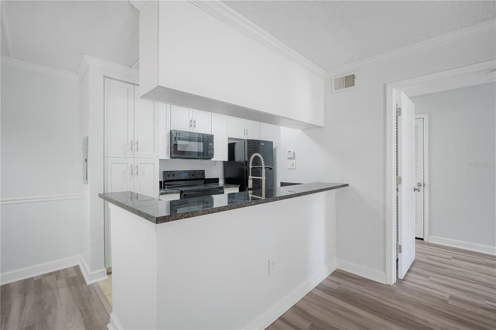 5305 San Sebastian Court, Unit 125 Tampa, FL 33609 - Photo 7 of 21 a kitchen with stainless steel appliances granite countertop a refrigerator and a stove top oven