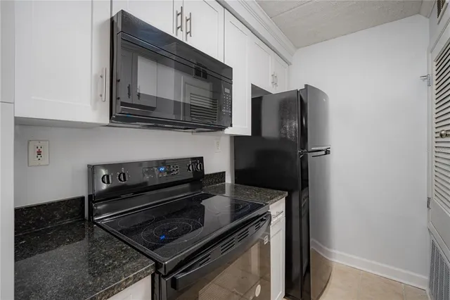 a kitchen with stainless steel appliances and cabinets