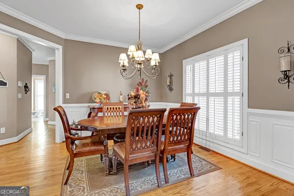 a view of a dining room with furniture and wooden floor
