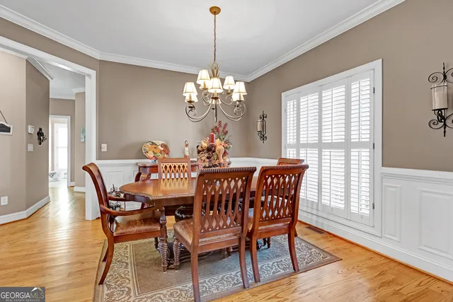 a view of a dining room with furniture and wooden floor