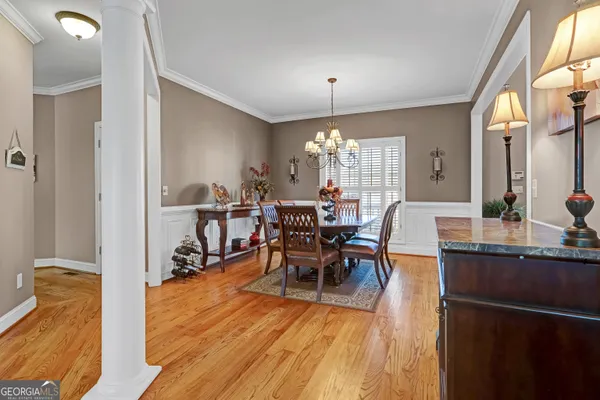 a view of a dining room with furniture window and wooden floor