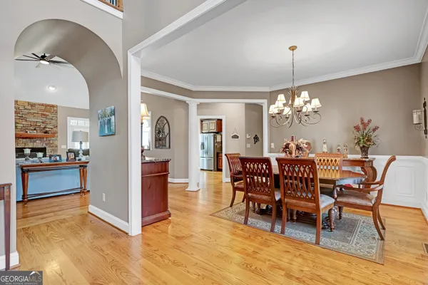 a living room with furniture a dining table and chairs in it