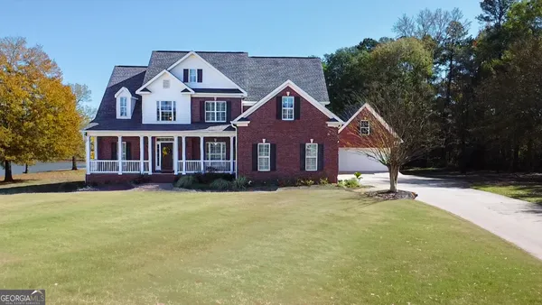 a front view of a house with yard porch and green space