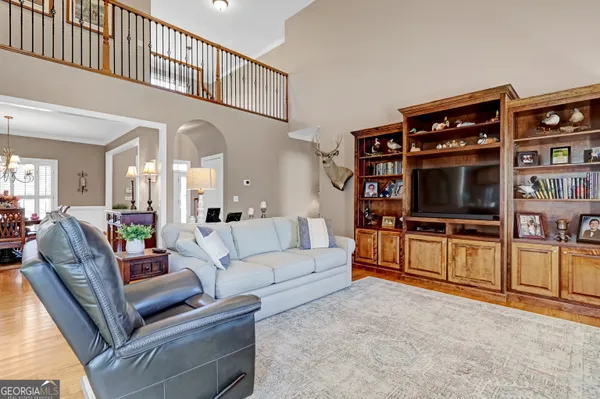 a living room with fireplace furniture and a wooden floor