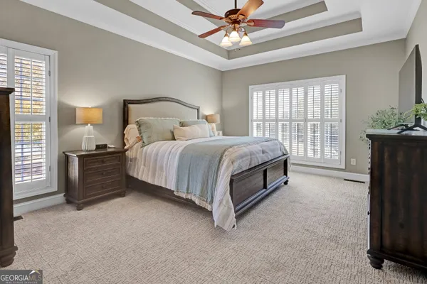 a spacious bathroom with a double vanity sink a mirror a window and a shower