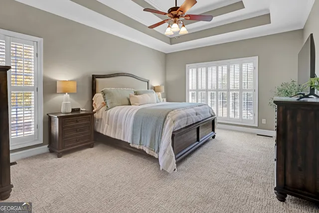 a spacious bathroom with a double vanity sink a mirror a window and a shower