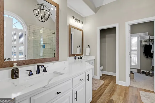 a bathroom with a tub a sink and a shower