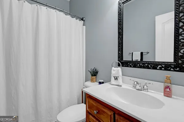 a living room with furniture and a ceiling fan