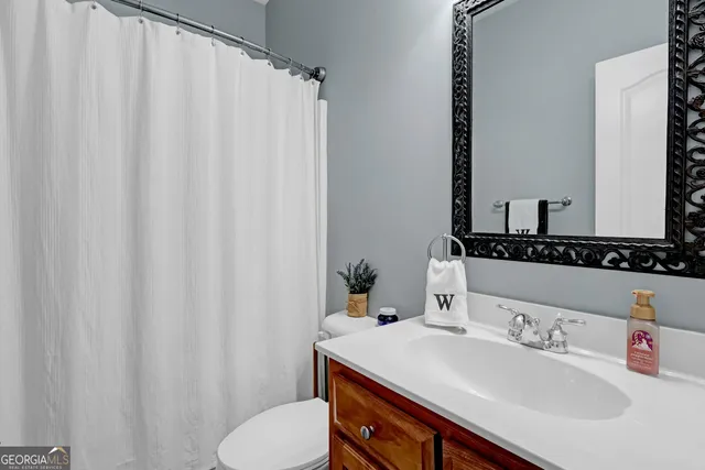a living room with furniture and a ceiling fan
