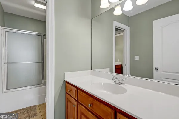 a living room with furniture a ceiling fan and a window