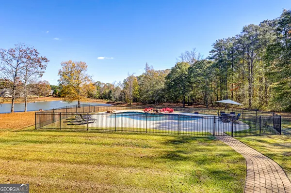 a view of yard with swimming pool and trees