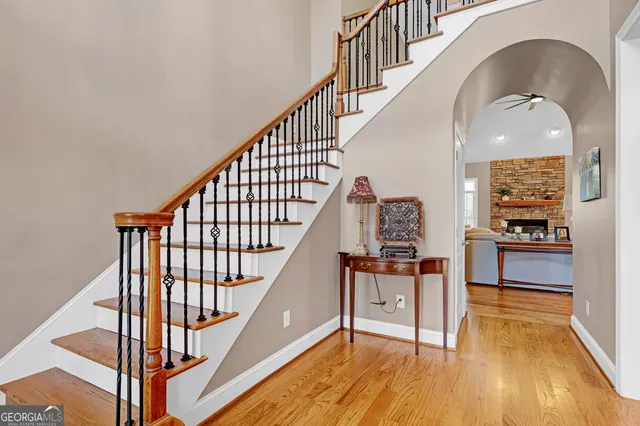 a view of a livingroom with wooden floor and staircase