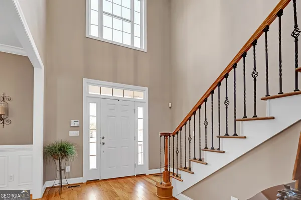 a view of an entryway with wooden floor