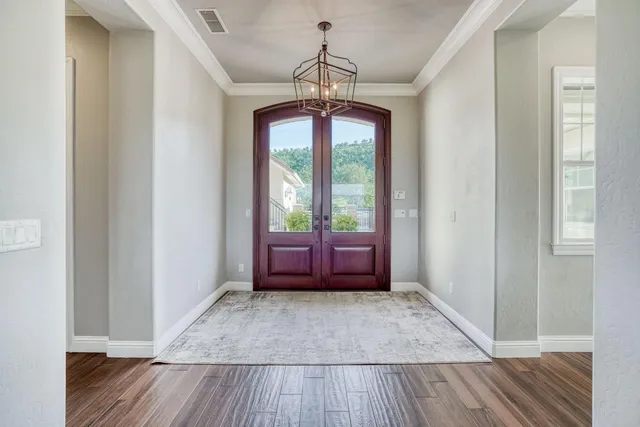 a kitchen with granite countertop a sink stainless steel appliances and cabinets